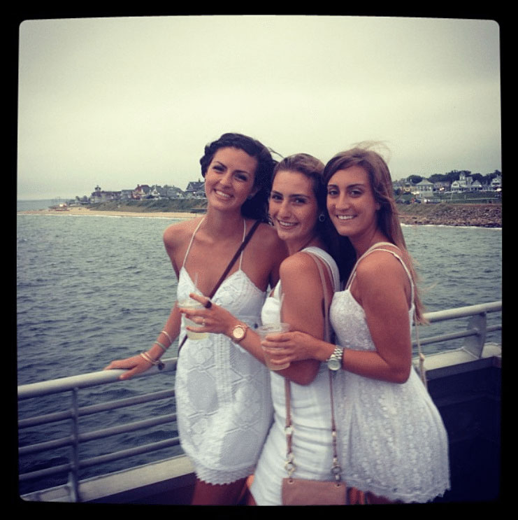 Three women dressed in white on the top deck