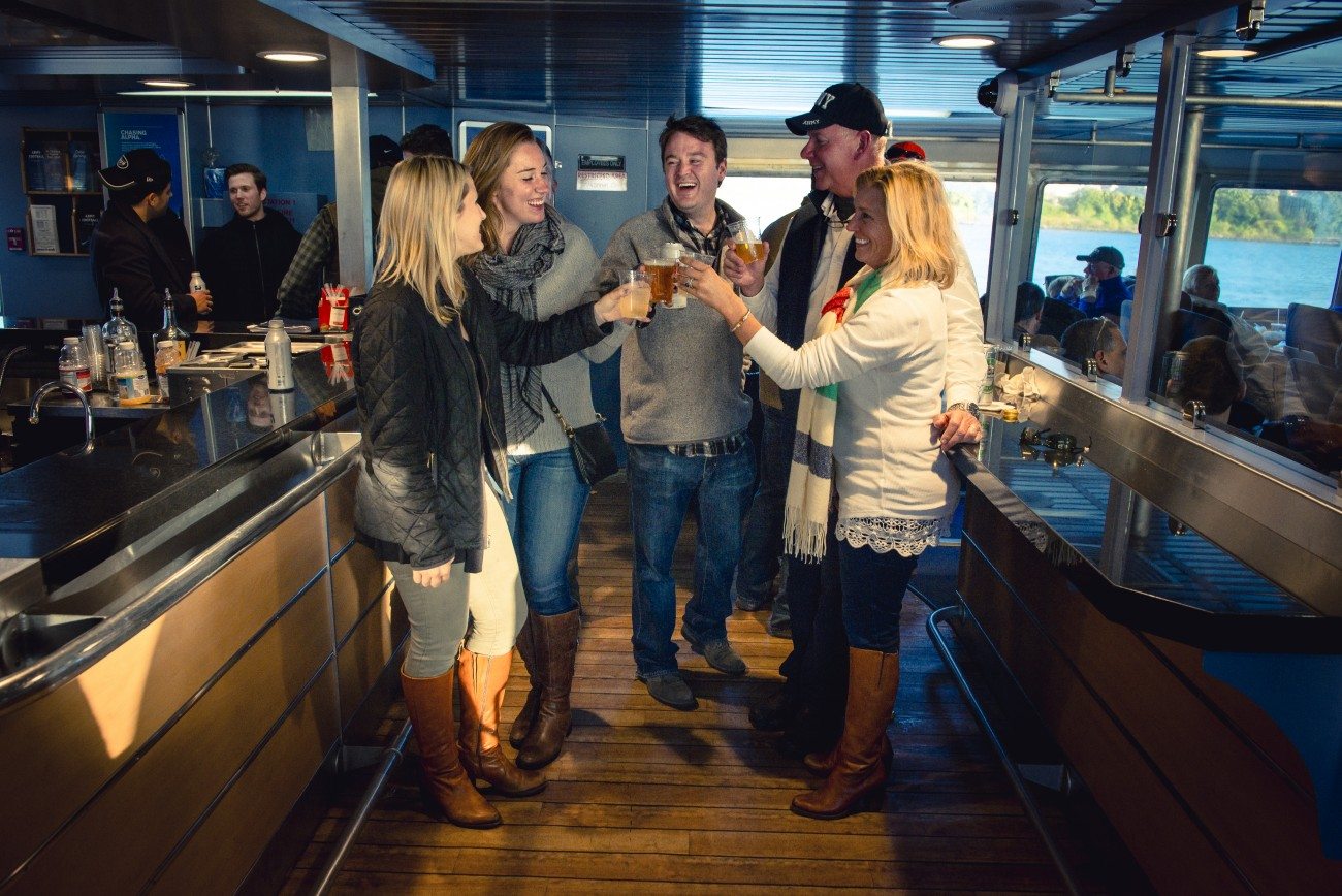 Passengers enjoying beverages inside the ferry