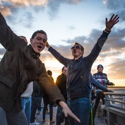 Passengers posing for the camera on the top deck of the ferry
