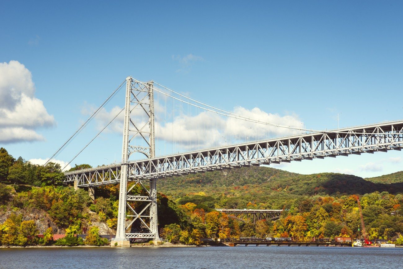 A bridge over the river with fall colors in the background