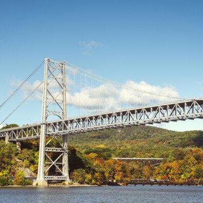 A bridge over the river with fall colors in the background