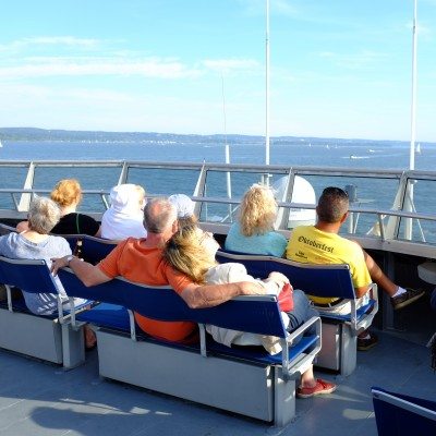Passengers relax on the top deck of the Seastreak Ferry
