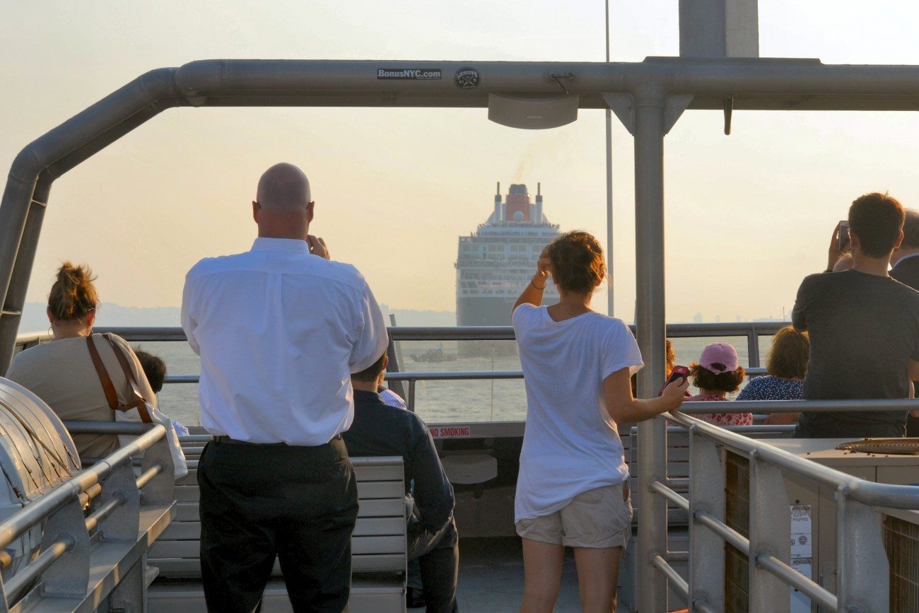 Passengers look out on the water from the top deck of the Ferry
