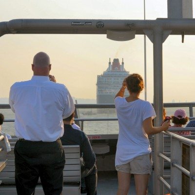 Passengers look out on the water from the top deck of the Ferry