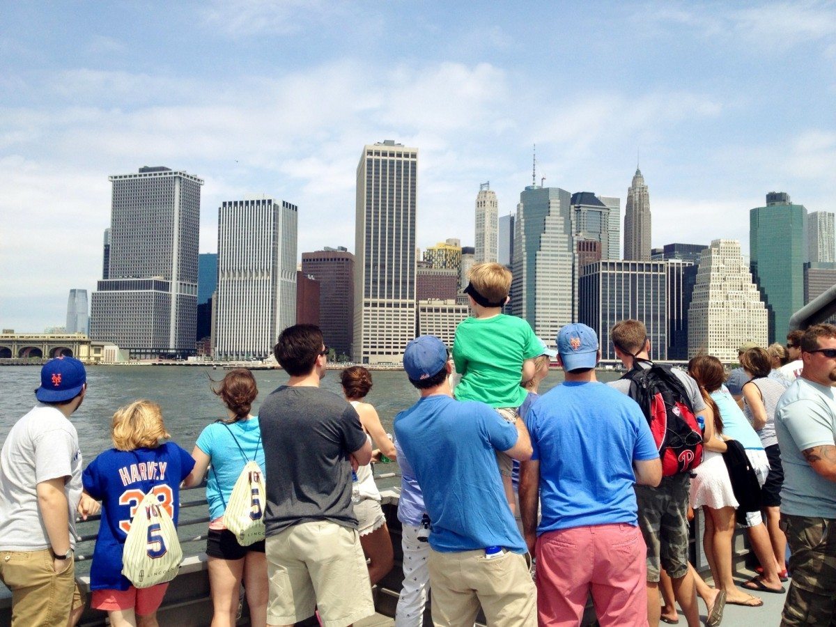 Mets fans look out on the water from the top deck of the ferry