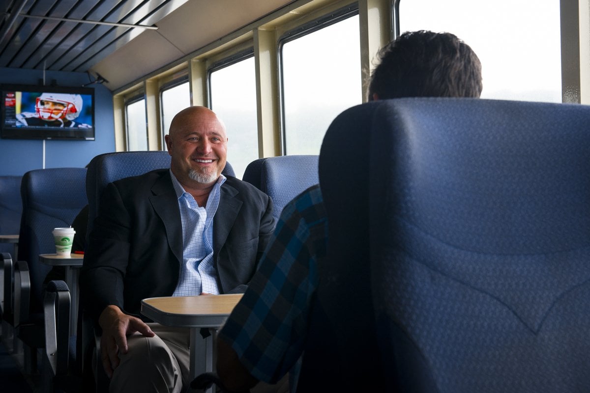 Two businessmen sit around a table on the ferry