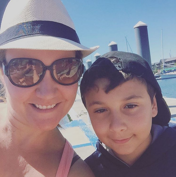 A woman and boy take a selfie on the ferry dock