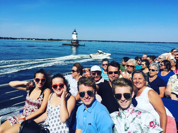 A group of people smiling for the camera on the ferry